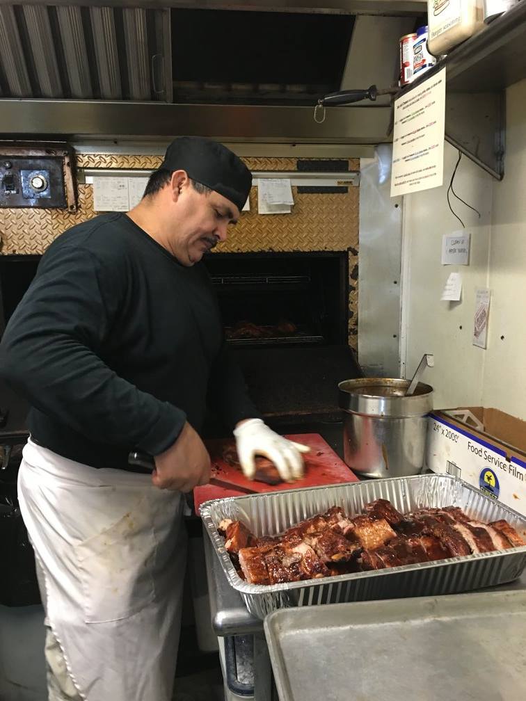 Saul Escalera prepares some barbecue for Red Rock Cafe and Back Door BBQ in Napa Valley CA