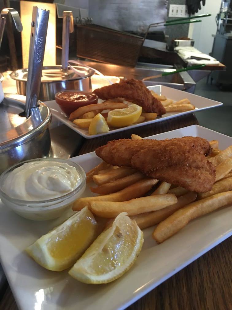 Extra large crispy fish fillets on a bed of hot French fries