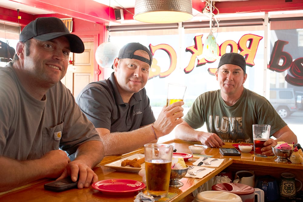 Happy customers enjoy barbecue lunch at the bar at Red Rock Cafe and back Door BBQ in napa Valley CA