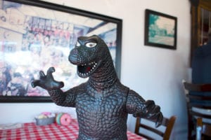 A toy of Godzilla sits at Red Rock Cafe and back Door BBQ